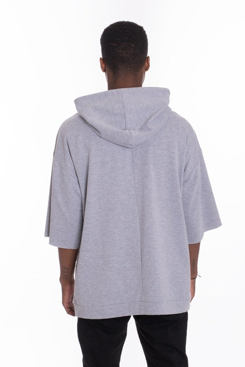 Person wearing a gray hoodie from behind on a white background