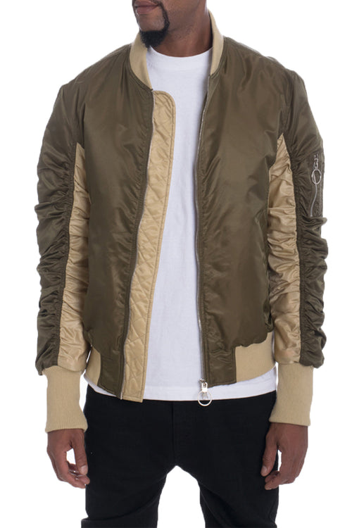 Man wearing a green and beige jacket with a white shirt underneath on a white background