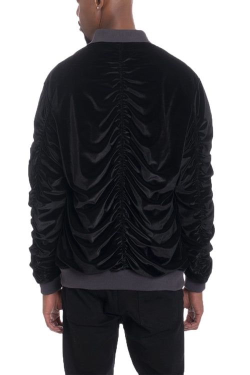 Black ruched jacket worn by a person on a white background