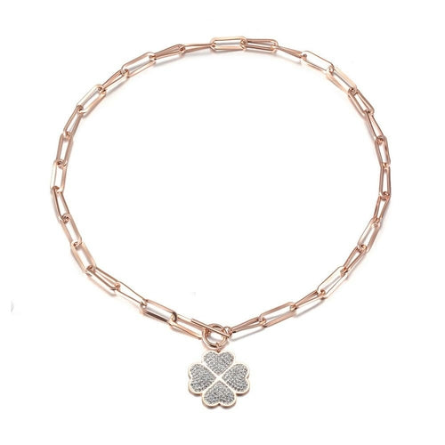 Rose gold chain bracelet with a clover-shaped charm on a white background