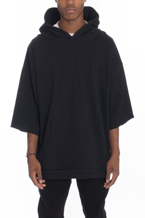 Person wearing a black hoodie on a white background