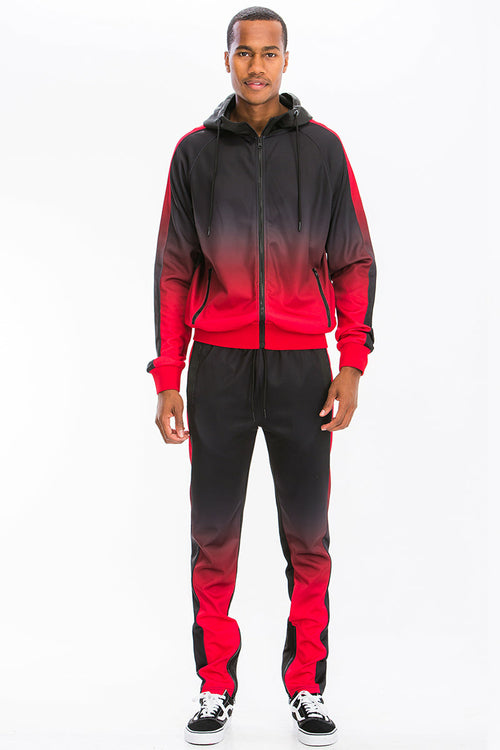 Man wearing a black and red gradient tracksuit on a white background