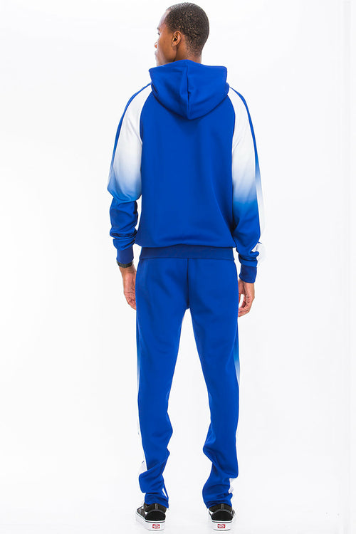 Person wearing a blue and white gradient tracksuit on a white background