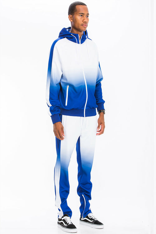 Person wearing a blue and white gradient tracksuit on a white background