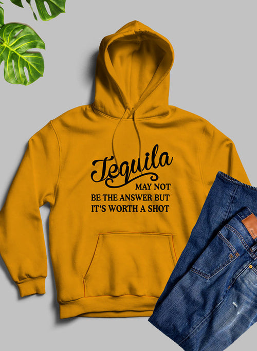 Yellow hoodie with 'Tequila may not be the answer but it's worth a shot' text on a gray background with jeans.