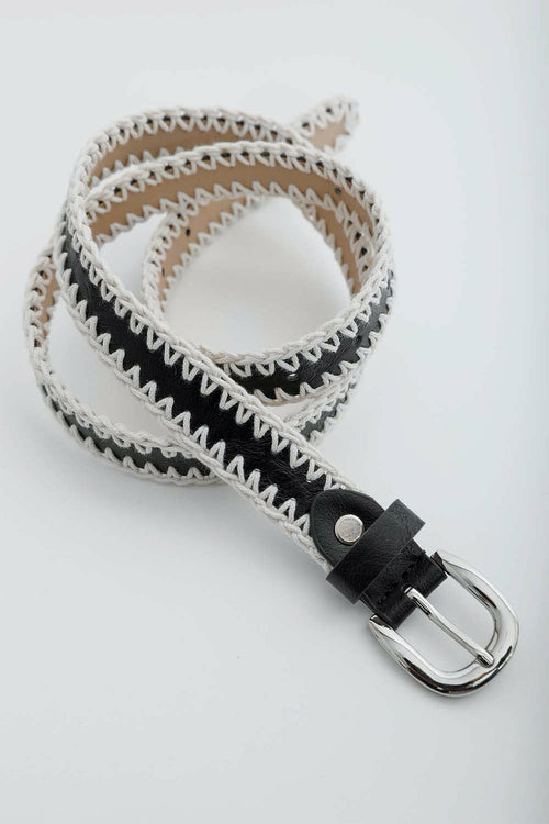 Belt with black and white striped pattern on a light gray background