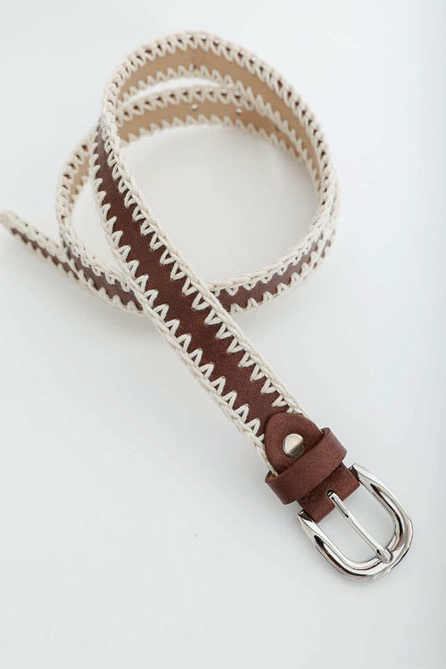 Woven belt with brown leather buckle on a white background