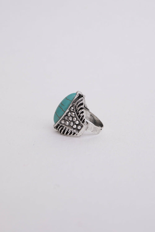Silver ring with turquoise stone on a white background