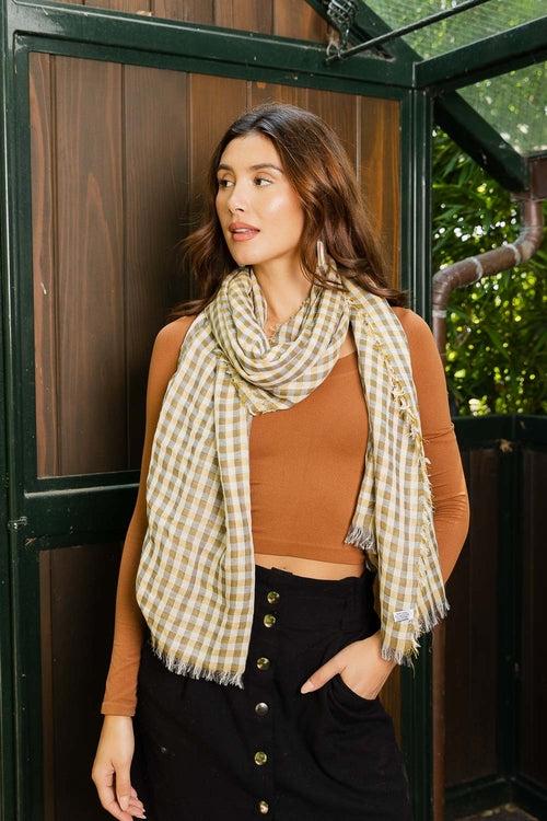 Woman wearing a plaid scarf in an outdoor setting