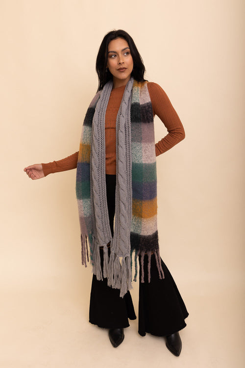 Woman wearing a colorful scarf on a beige background