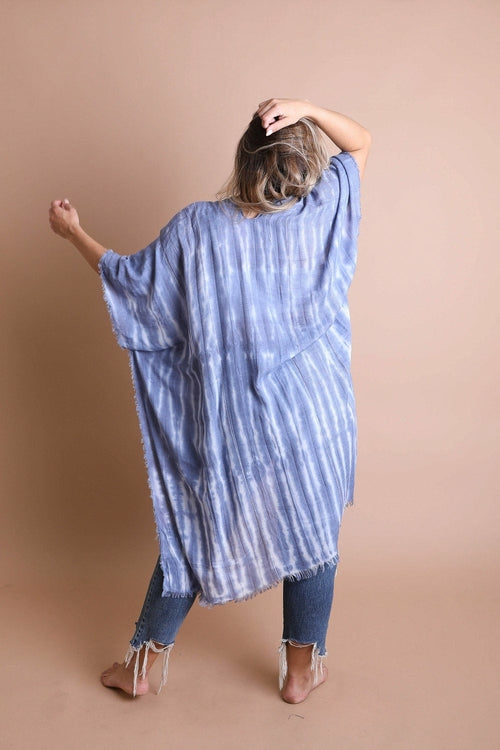 Person wearing a blue and white striped shirt with a plain background