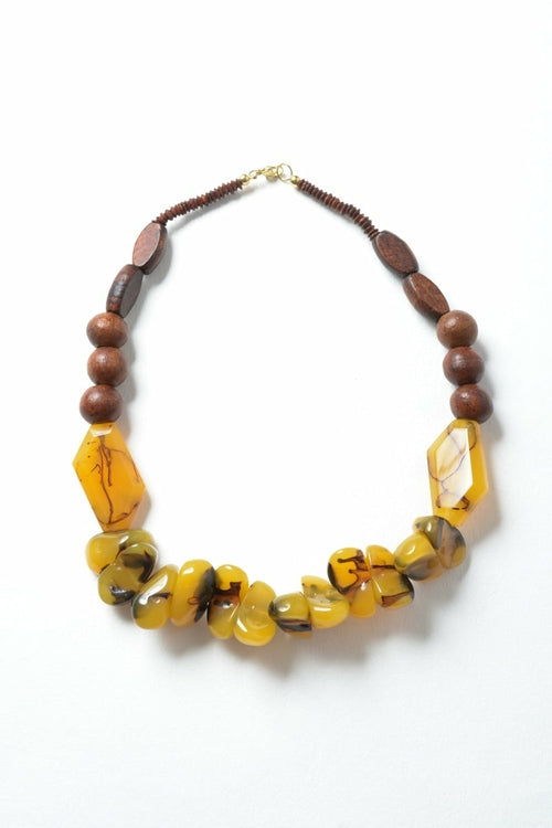 Necklace with brown and yellow beads on a white background