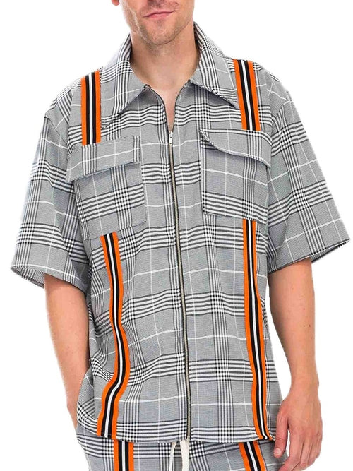 Person wearing a plaid shirt with orange and black accents on a white background