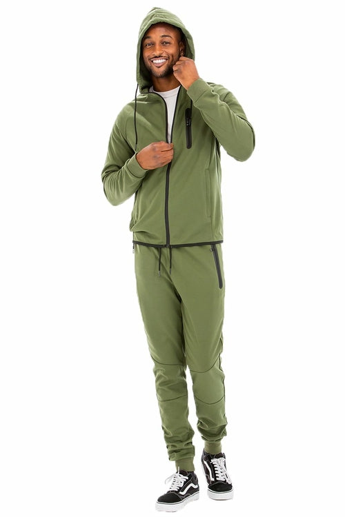 Man wearing a green tracksuit on a white background