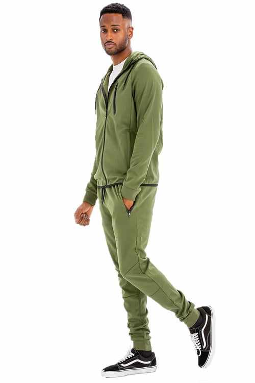 Man wearing a green tracksuit on a white background