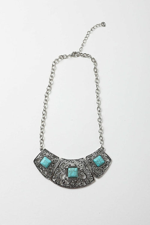Necklace with turquoise stones and silver chain on a white background