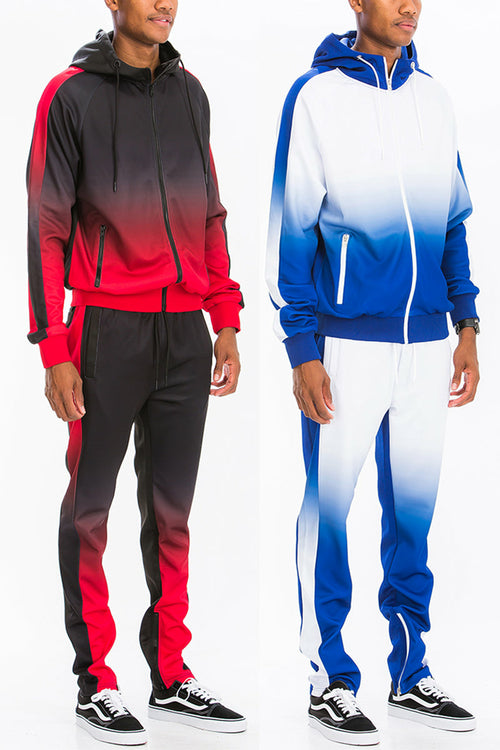 Two people wearing gradient tracksuits, one red and black, the other blue and white, on a white background.