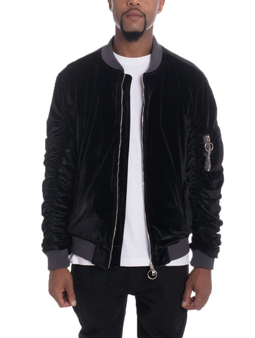 Black velvet bomber jacket worn by a person on a white background