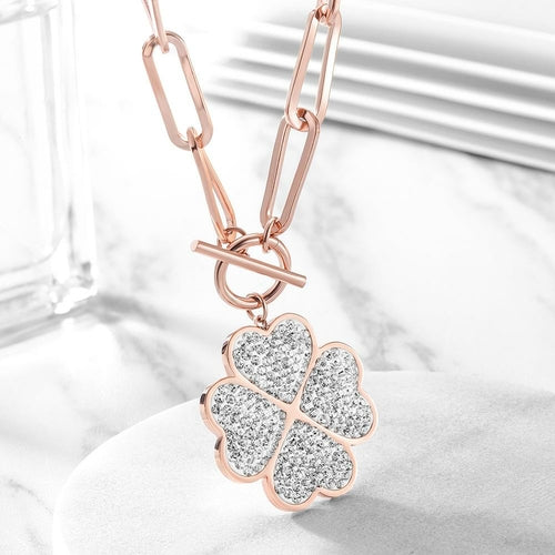 Rose gold necklace with a four-leaf clover pendant on a white background