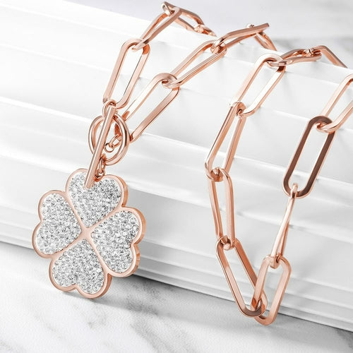 Rose gold bracelet with a clover-shaped diamond pendant on a white background