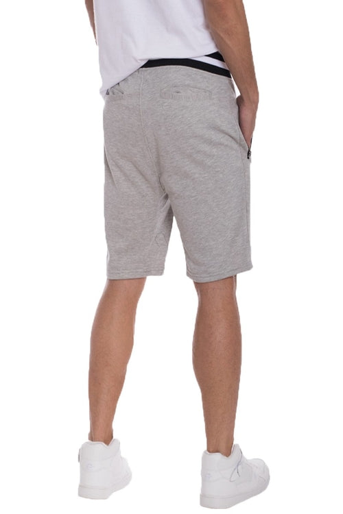 Person wearing gray shorts on a white background