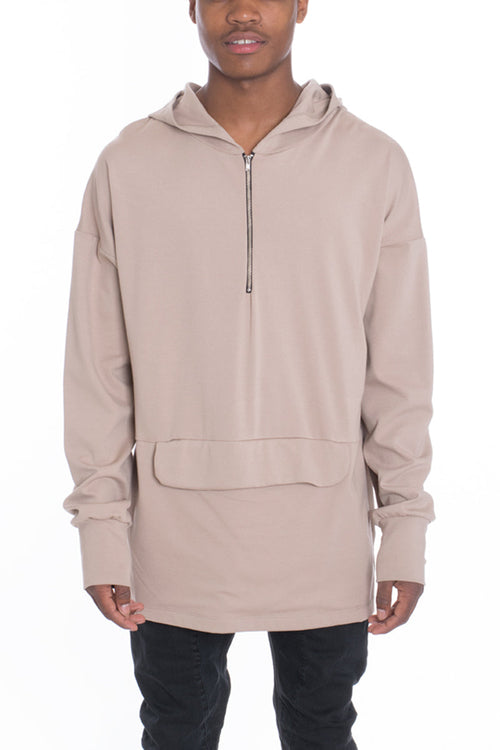 Beige hoodie with a zipper worn by a person on a white background
