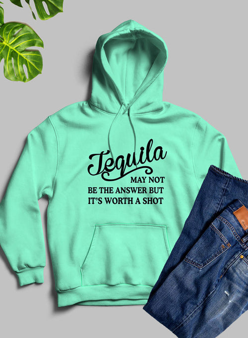 Mint green hoodie with 'Tequila may not be the answer but it's worth a shot' text, paired with jeans on a gray background.