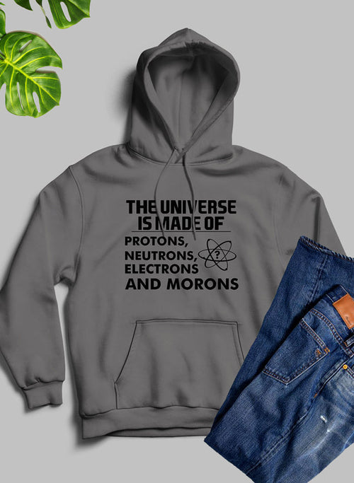 Gray hoodie with humorous text design on a light gray background with jeans and plant leaves.