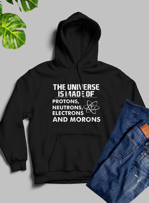 Black hoodie with humorous text design on a gray background with jeans and plant.