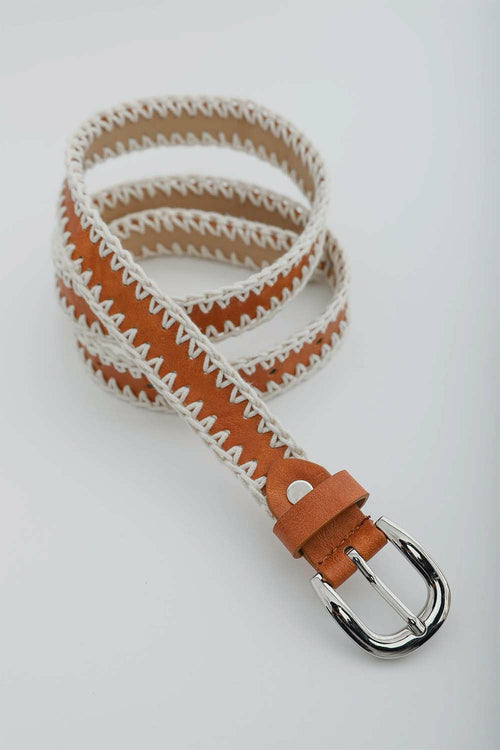 Woven belt with brown and white pattern on a light gray background