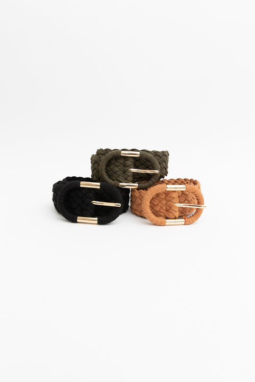 Three woven bracelets in black, brown, and green on a white background