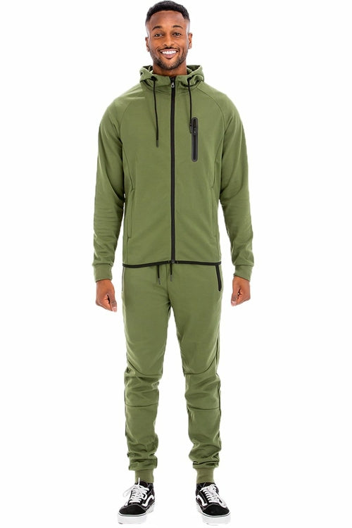 Man wearing a green tracksuit on a white background